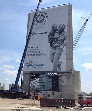150 ton A/T crane installing a large banner above the Orange Barrel Media building in Columbus, Ohio.